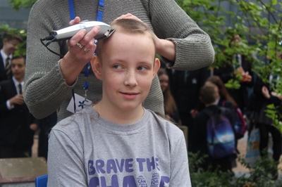 Ethan Braves the Shave in front of whole school